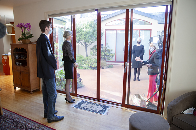 Doudn's family watching new arrivals from inside the house