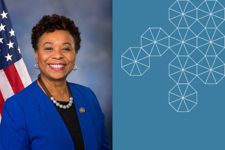 Barbara Lee smiling with American flag in the background