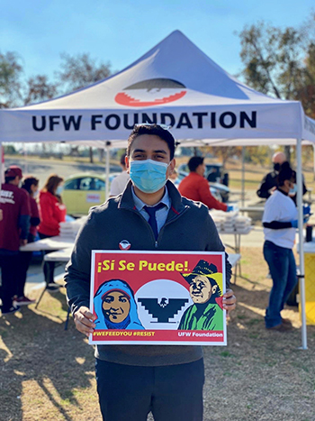 Bryan Osorio Trujillo, the new major of Delano, holds up a sign in support of the United Farm Workers at a recent union event in Bakersfield.