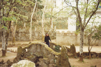 Julie stands in a forest in Chaves, Portugal 