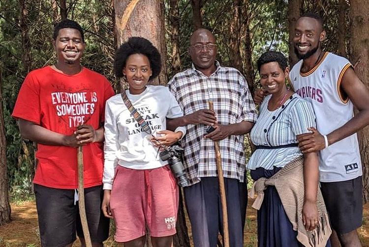 Graduate student Gloria Tumubashe's family in Uganda poses, all in a row in front of trees