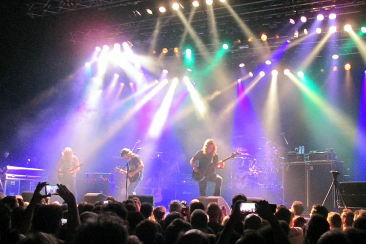 A band plays a show on stage at a concert.