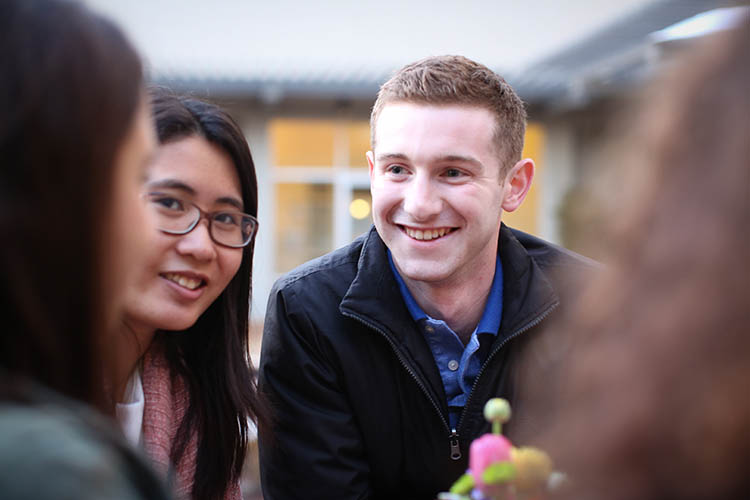 a young man and woman smile at the camera