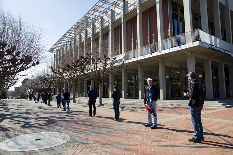 A long line of campus students, faculty and staff on Sproul Plaza shows the steady flow of people getting COVID-19 vaccines in Pauley Ballroom, in the Martin Luther King Jr. Student Union.