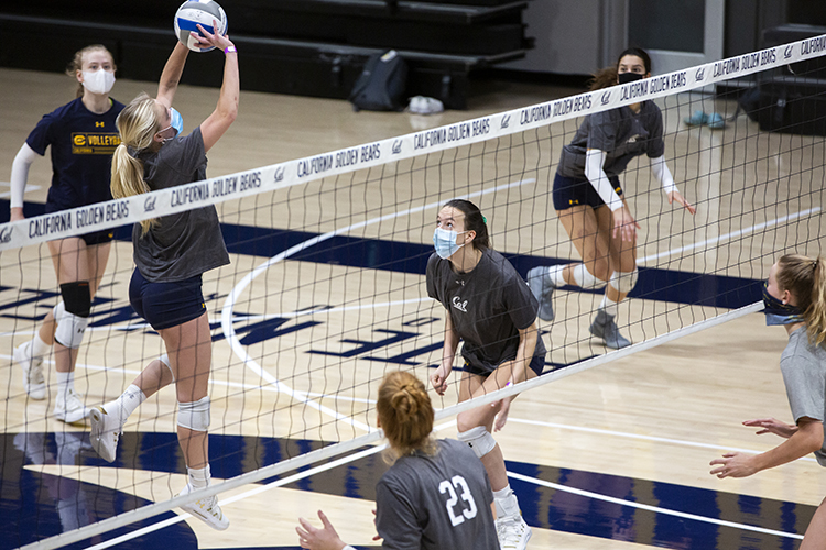 The women's volleyball team practices in Haas Pavilion wearing masks to prevent the spread of the coronavirus.