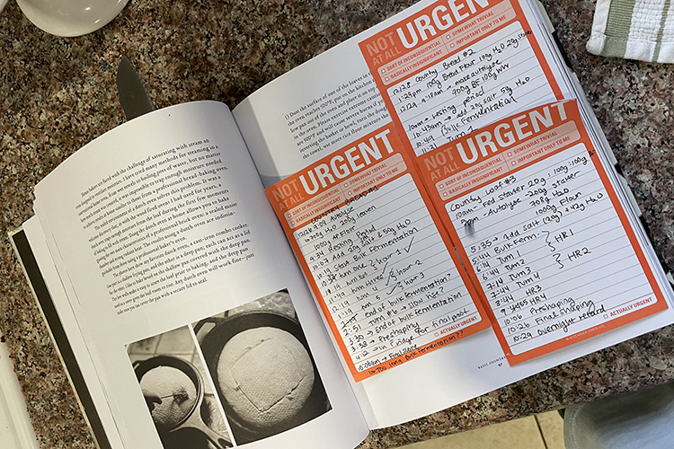 A recipe book used by the bread bakers contains post-it notes and photos.