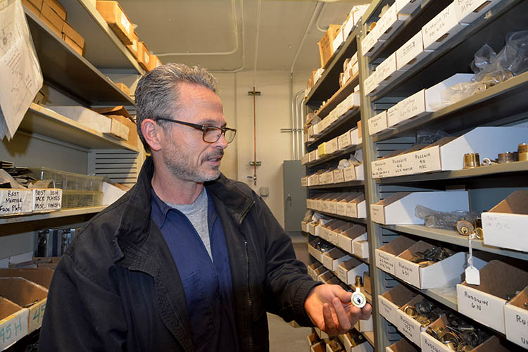 jeff bovie looks at a bank of locks