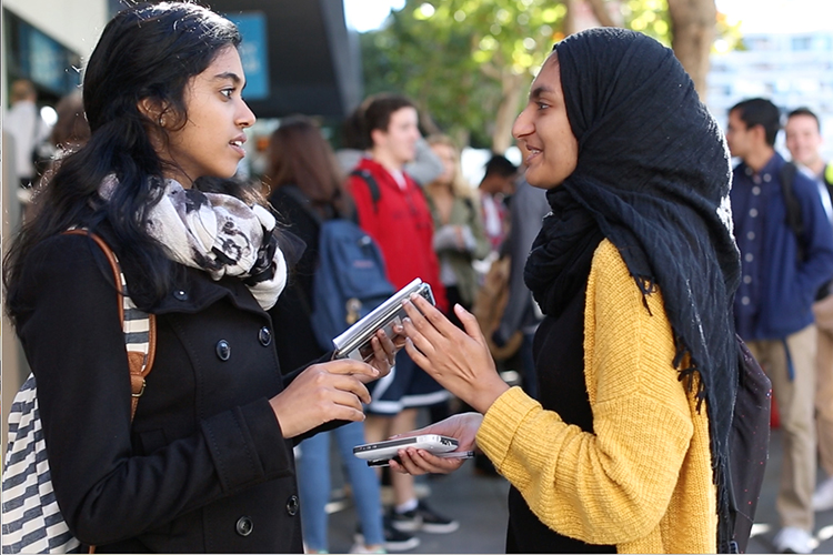 Two female students in the Fall Program for Freshman at UC Berkeley talk between classes.