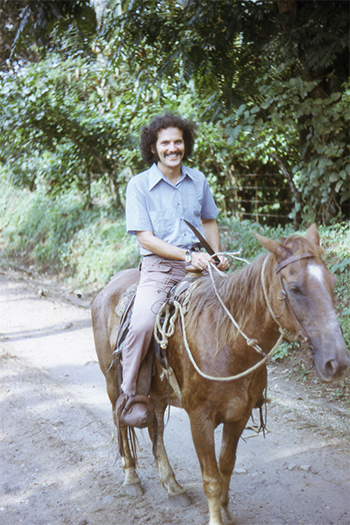 In his 20s, Harley Shaiken rides a horse in Central America