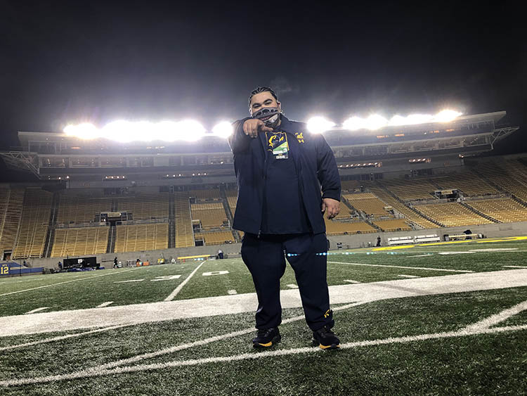 Morino Baca points at the camera in Memorial Stadium 