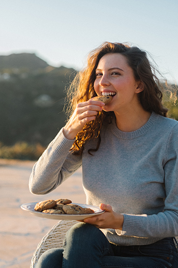 First-year student and teen writer Sadie Radinsky eats a dessert that she created a recipe for, one of many recipes in her new book.