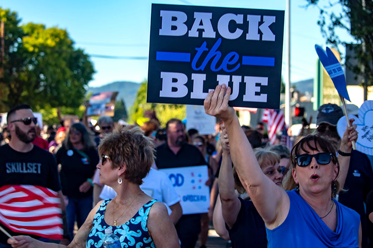 Pro-police Blue Lives Matter protesters, with one carrying 