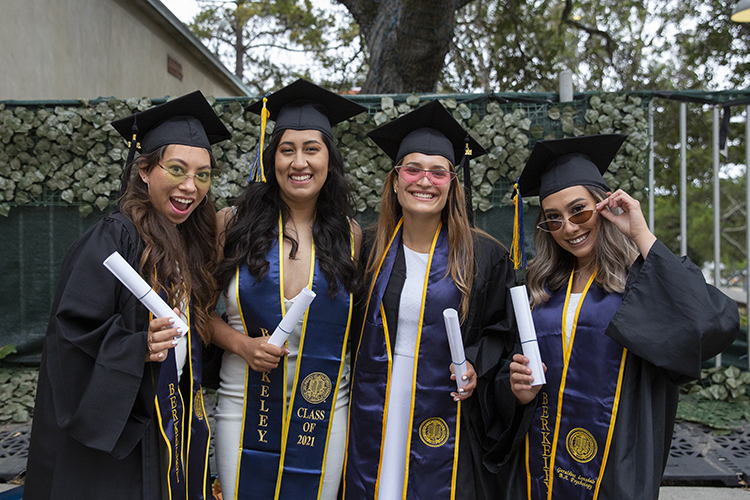 Wearing flashy sunglasses and smiles, friends Pamela George, Yazmin Renteria, Laila Elias and Geraldine Lonsdale pose for a photo after the graduation ceremony.