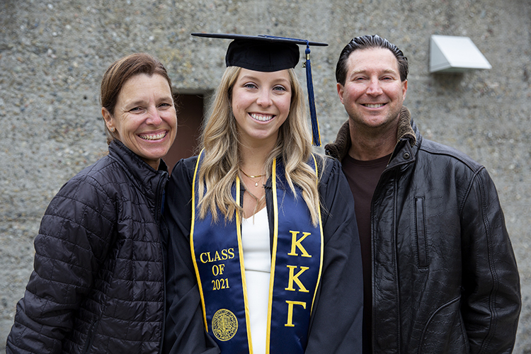 Michelle and Mike Hanlon are all smiles with their daughter, Lindsey, after watching her process across the Greek Theatre stage on their cell phones outside the gates.