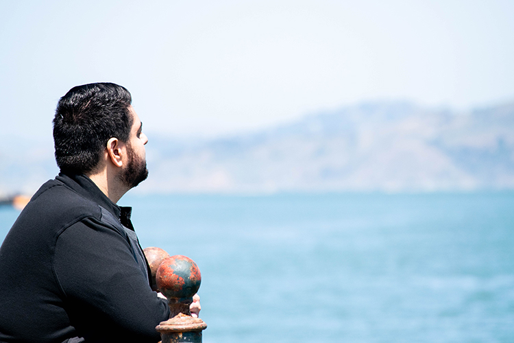 Harris Mojadedi looks out at the bay from Pier 7.