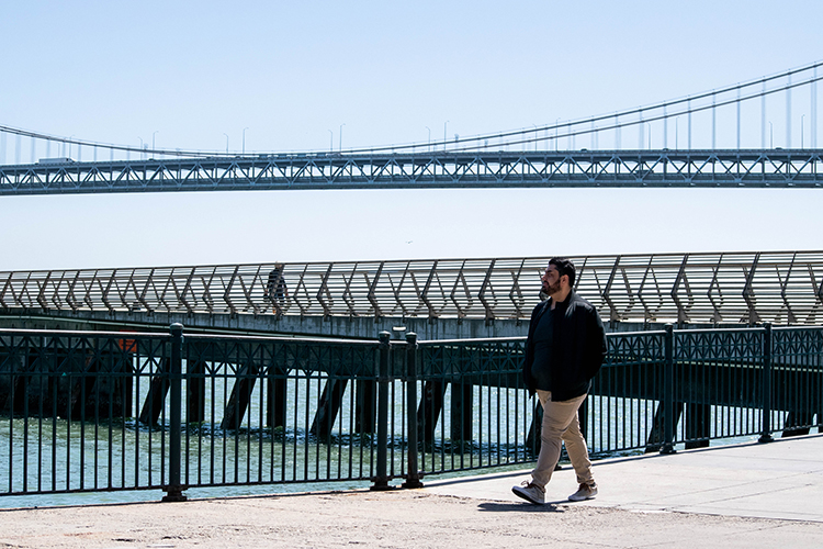 Harris Mojadedi walks along San Francisco Bay off the Embarcadero