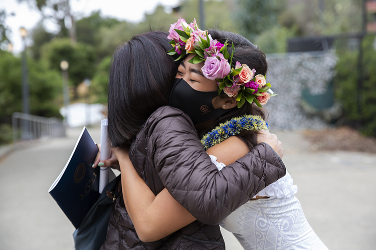 Paris Soto and her mom, Karen Sakamoto, hug each other tightly after Soto finished walking across the Greek Theatre stage.