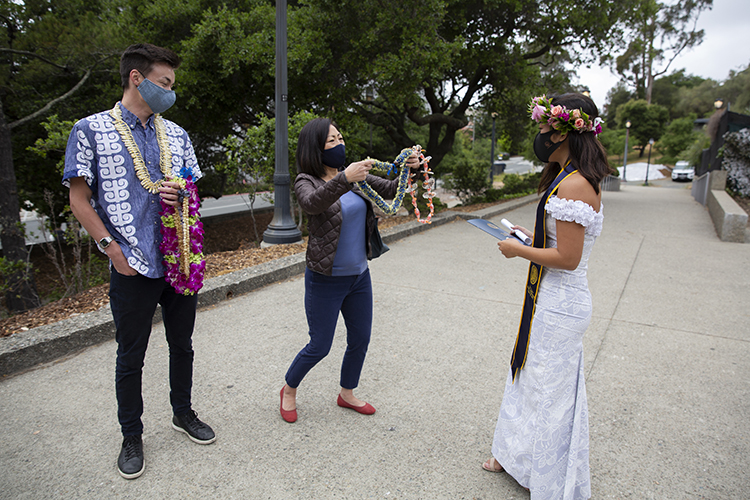 After Paris Sato exited the Greek Theatre, her mom, Karen Sakamoto, and boyfriend, Karl Keck, greeted the architecture graduate with leis brought from Hawaii by Sakamoto.
