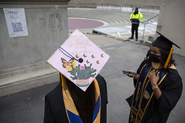 A student-decorated mortarboard, colored pink with butterflies and flowers, stood out from the crowd at the Greek Theatre procession on Sunday.