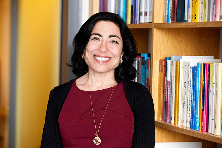 A portrait of Jennifer Chayes standing in front of a bookcase