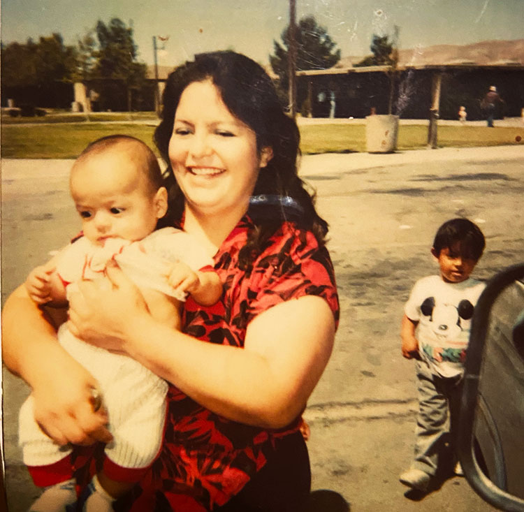 Childhood photo of Cai Carranza's mom holding their brother.