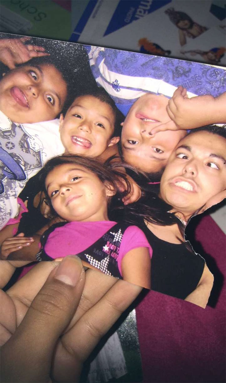 Childhood photo of Cai Carranza making silly faces with their siblings.