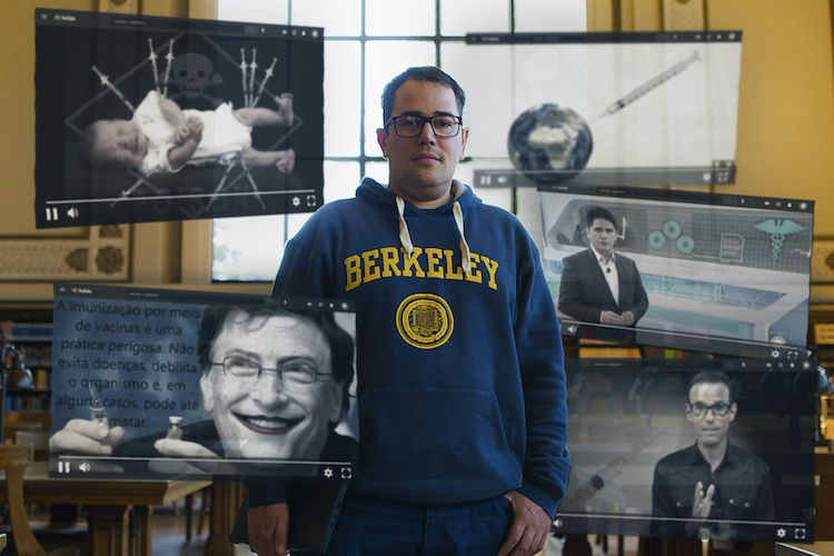 UC Berkeley data scientist Alexandre de Siqueira stands in doe library with virtual media clips floating around hm