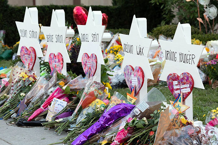 After the 2018 mass shooting at the Tree of Life Synagogue in Pittsburgh, Pennsylvania, mourners left flowers and markers to honor those slain.