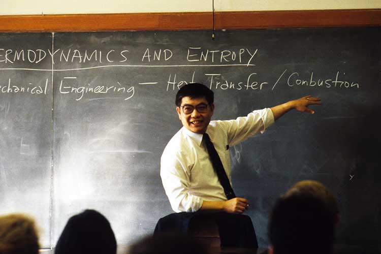 Archival photo of former Berkeley Chancellor Chang Lin-Tien teaching at a blackboard.