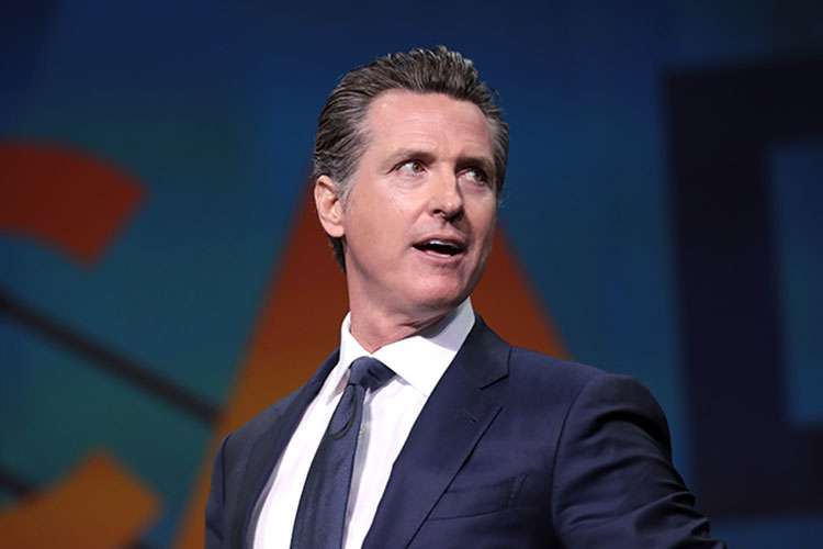 informal portrait of Gavin Newsom speaking at a political event