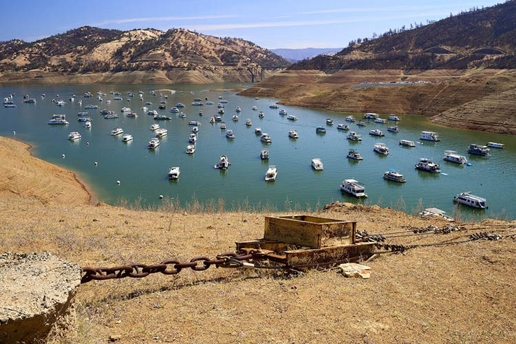 low water levels in a lake filled with boats