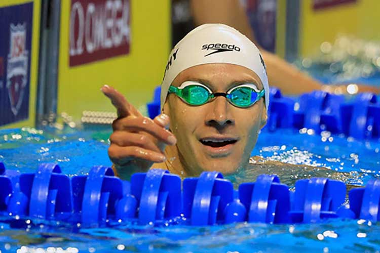 Cal swimmer Ryan Murphy in a pool pointing at the audience.