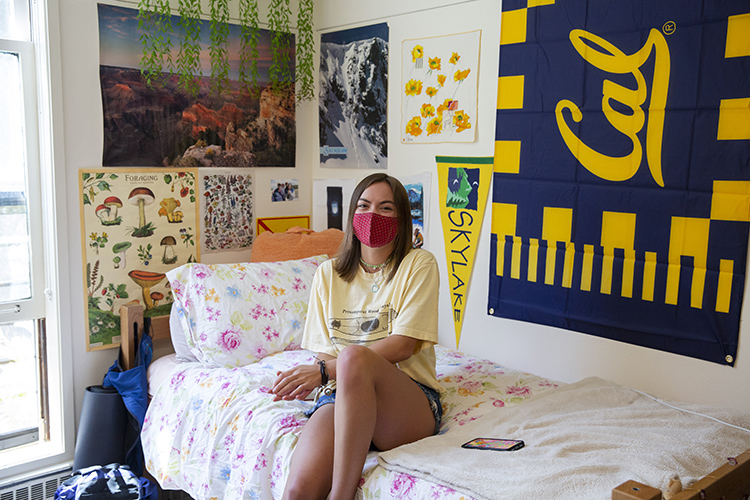 a student sits in her dorm room with 
