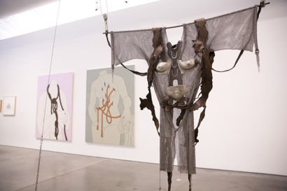 sculpture and paintings on the wall in an art gallery
