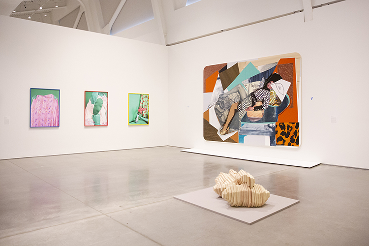 three paintings and a sculpture in a gallery