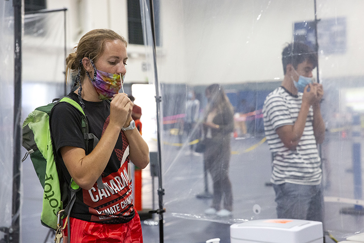 A student swabs her nose at the Rec Sports Facility testing site.