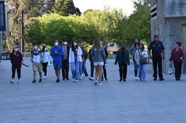 people walk in a group near memorial stadium