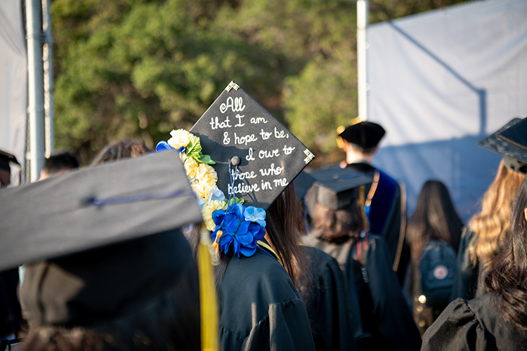 A graduate's mortarboard says, 