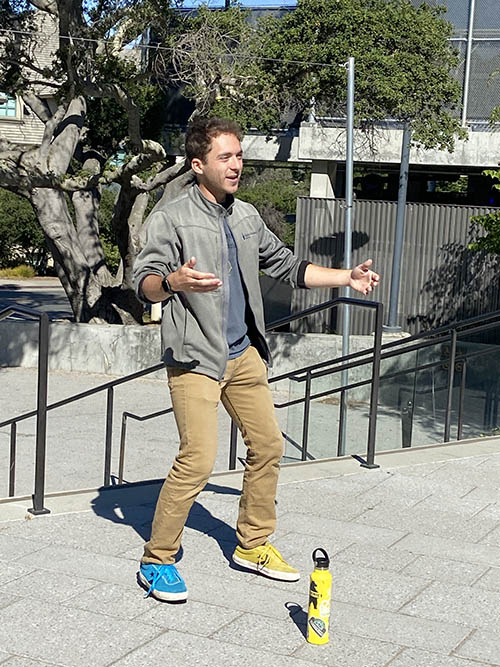 a tour guide gestures near a set of stairs