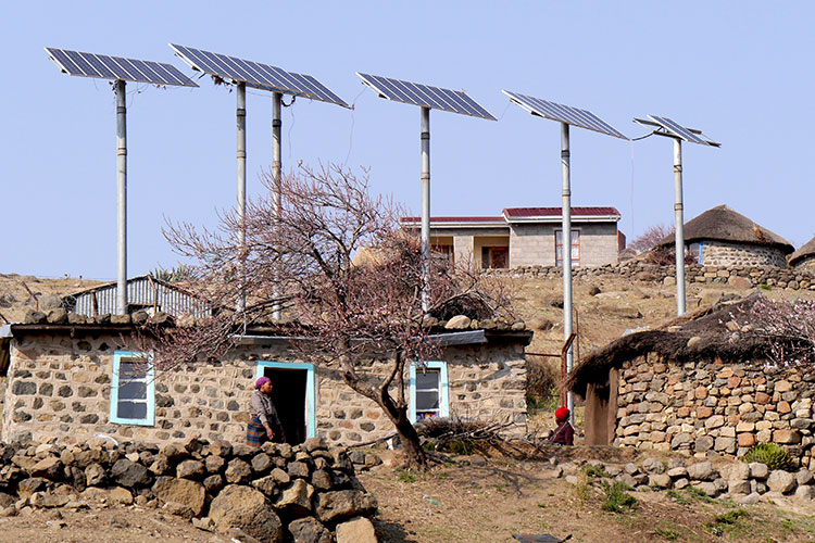 a small settlement of rock houses in Lesotho, Africa, with solar panels