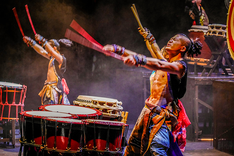 drummers perform on stage