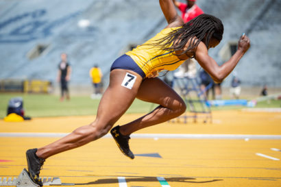 Ezinne Abba, a Cal Bears track and field runner and junior in molecular and cell biology, sprinting in a blue and gold outfit