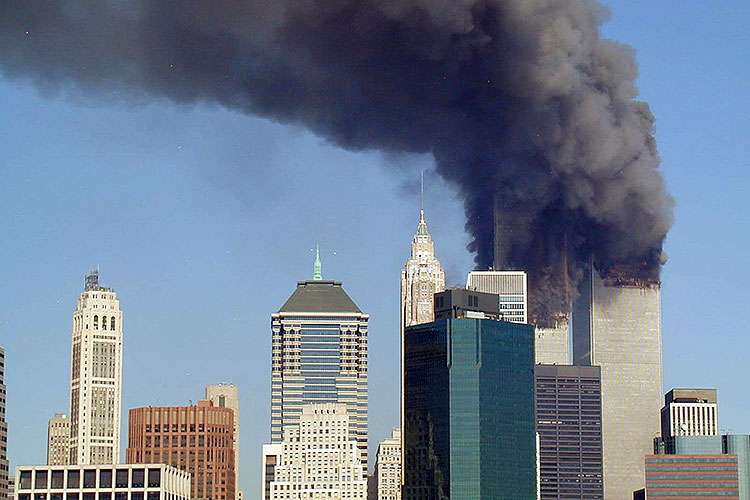 The Manhattan skyline, with the twin towers at the World Trade Center engulfed in flames and smokebu