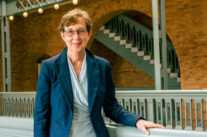 A photo of Kathy Yelick standing in a large lobby