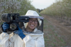 Kristin Hwang wearing a beekeepers outfit.