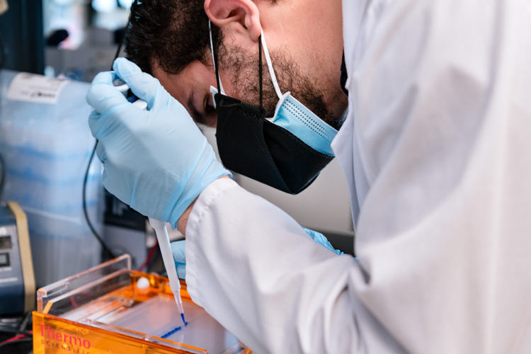 researcher in mask pipetting