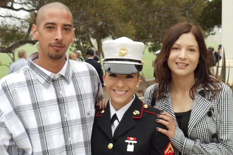 Gloria Kunder posing in her Marine uniform with her aunt and uncle.