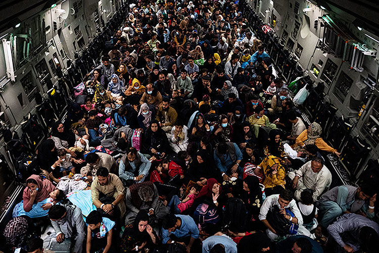 hundreds of Afghan people fleeing the Taliban waited in the belly of a military cargo plane which carried them out of the country