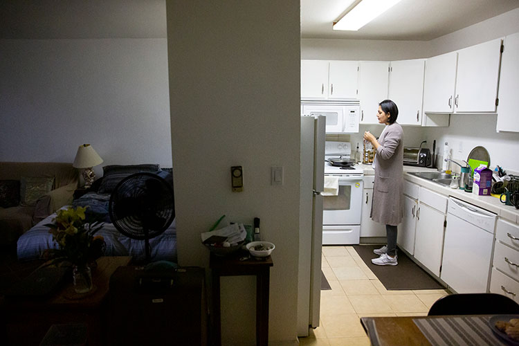 Khwaga Ghani during a thoughtful moment in the kitchen of a small East Bay apartment shared by her family