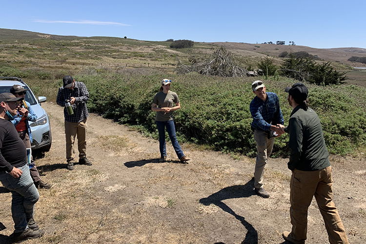 Professor Peter Nelson, a wildland firefighter, meets with Audubon Canyon Ranch staff on a dirt road near Toms Point, near Tomales Bay, to discuss a prescribed burn.